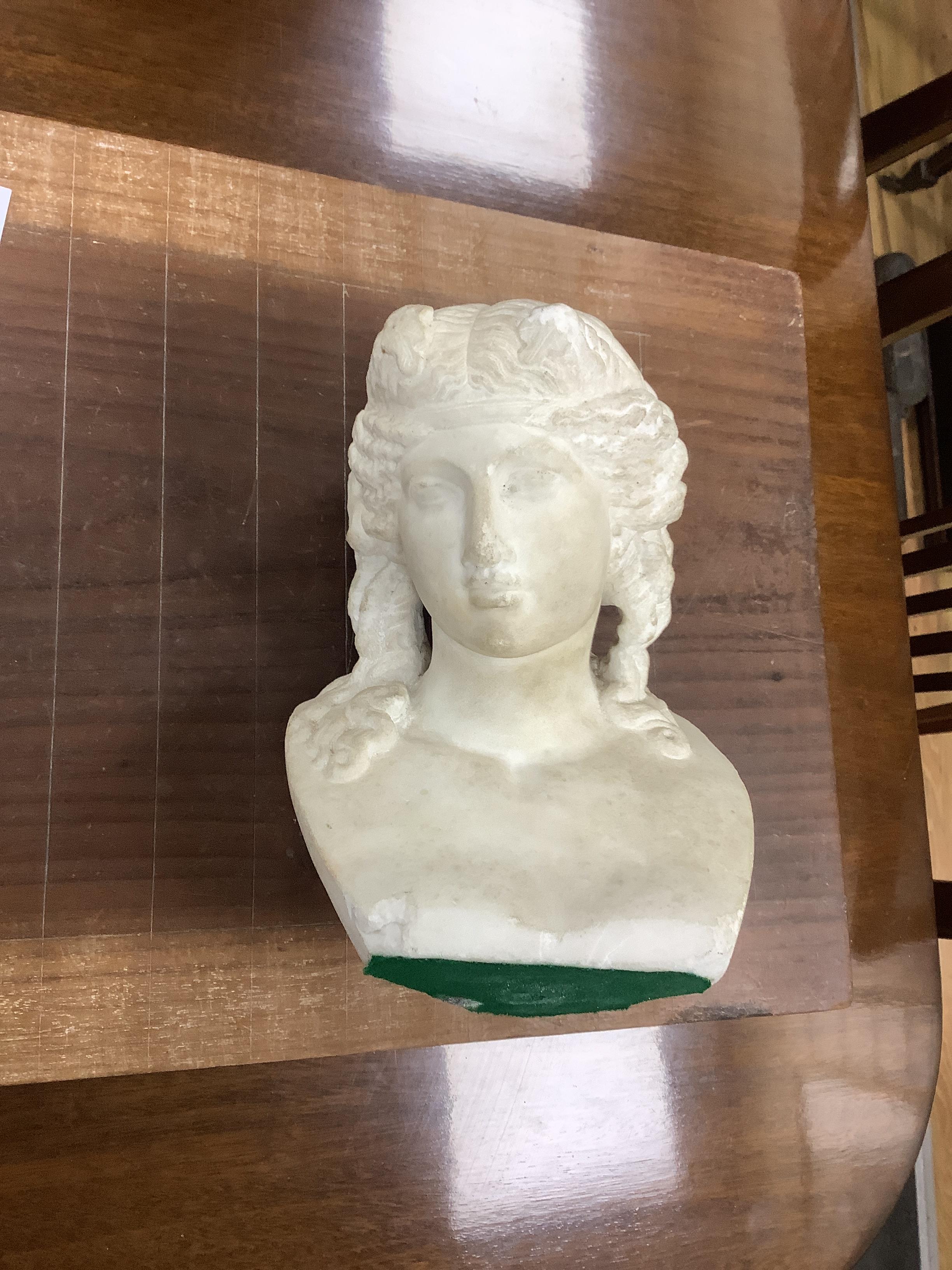 After the Antique, a carved marble bust of a young woman on octagonal onyx plinth and rosewood pedestal, combined height 142cm